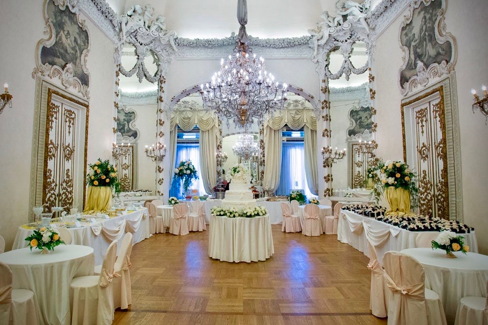 A beautiful hall for weddings in Rome, refined chandeliers, stucco's, mirrors, round table setting