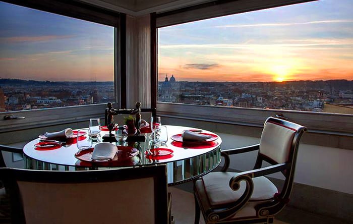 Romantic dinner table in the restaurant, with incredible view over rome during sunset