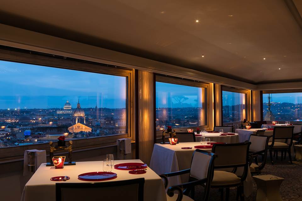 Night view of the restaurant, huge glass windows with incredible view over the eternal city