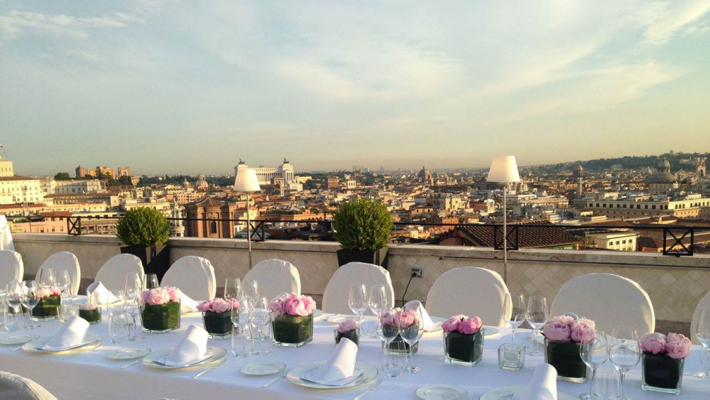 Terrace wedding set-up lunch with fresh flower's centerpieces with panoramic view over rome