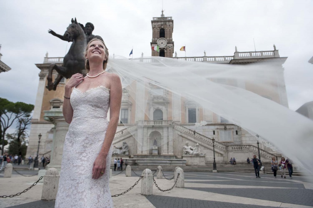 Bride with long veil in front of Campidoglio, Rome