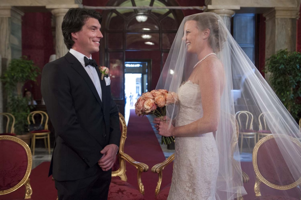 Bride and groom in the Red Hall in Campidoglio in Rome during civil wedding ceremony