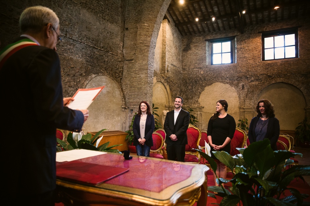 Ceremony celebrant with the couple and witnesses during a ceremony in Rome