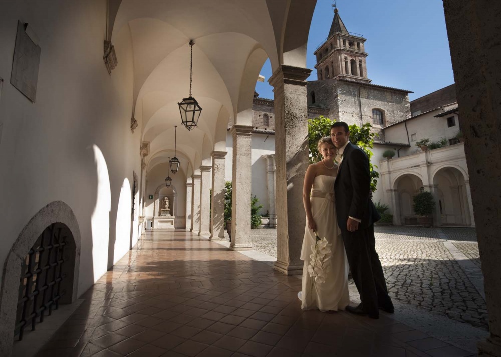 Bride and groom in a cloister in Tivoli Rome after wedding ceremony