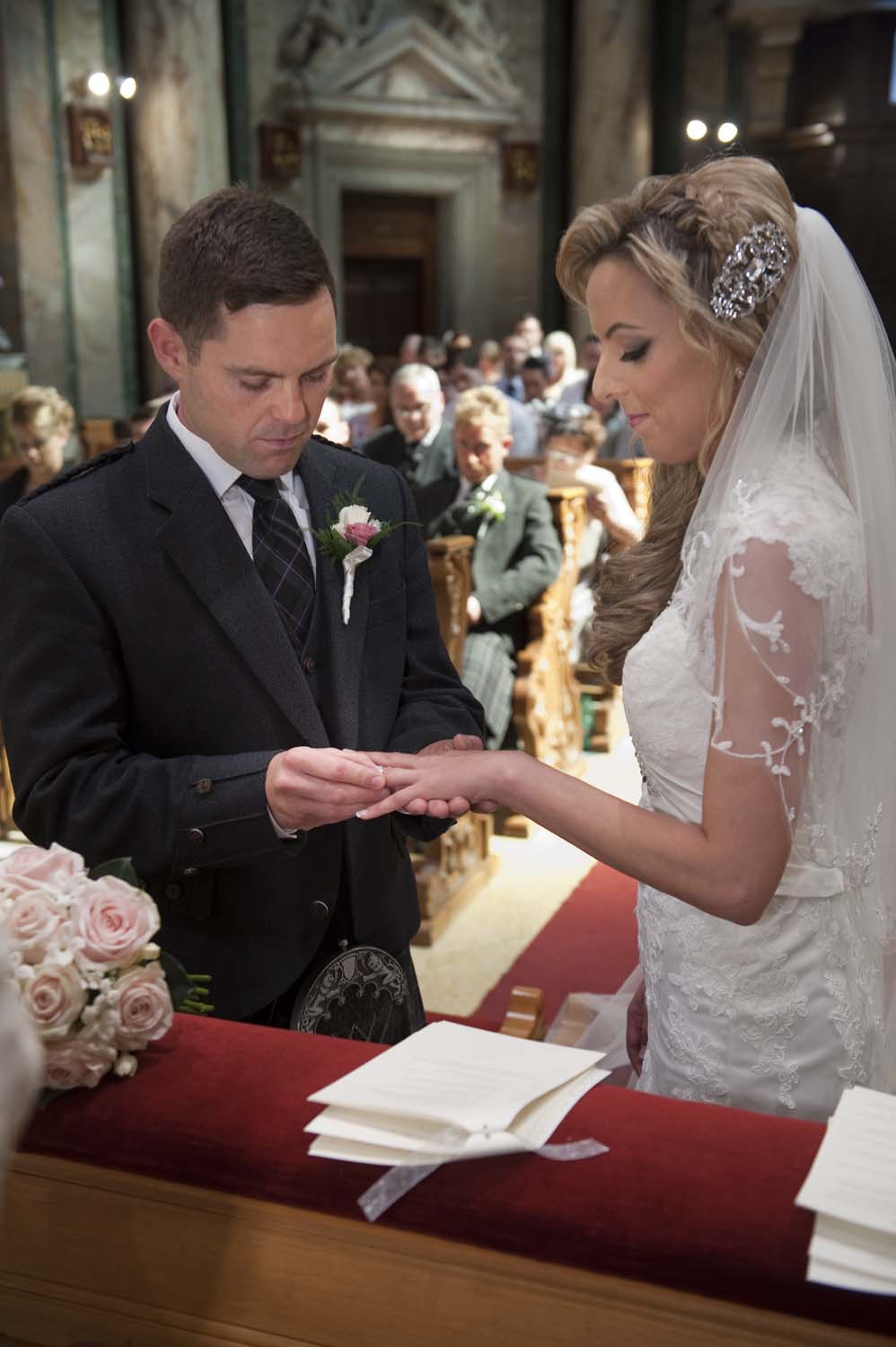 Moment of the exchange of rings in a Catholic ceremony in Rome