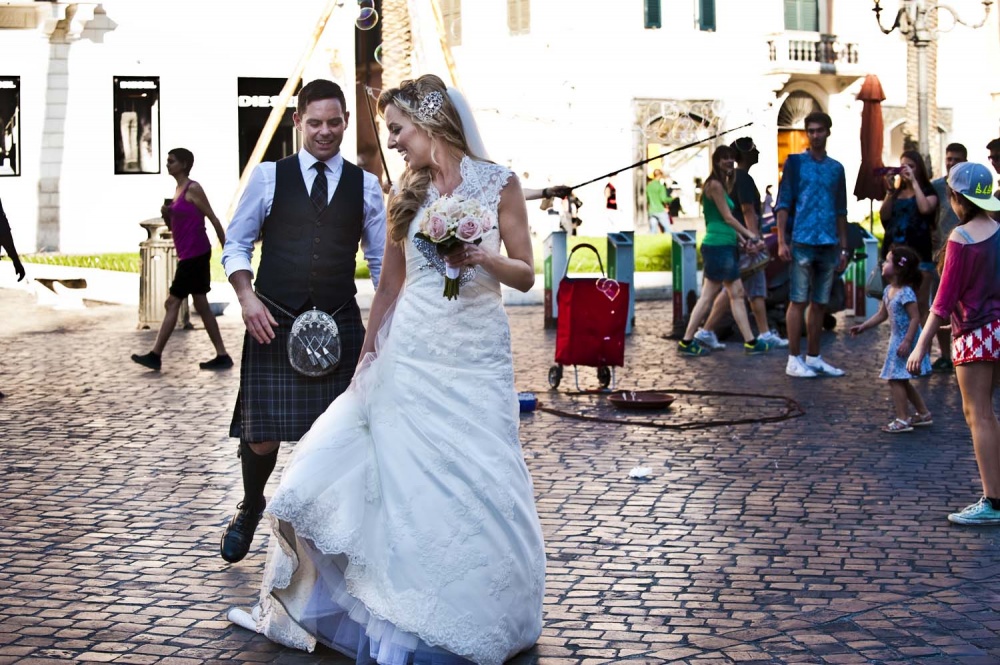 Bride and groom walking in Rome with tourists