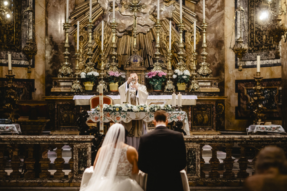 View of the altar enriched with candles and elegant flower decors 