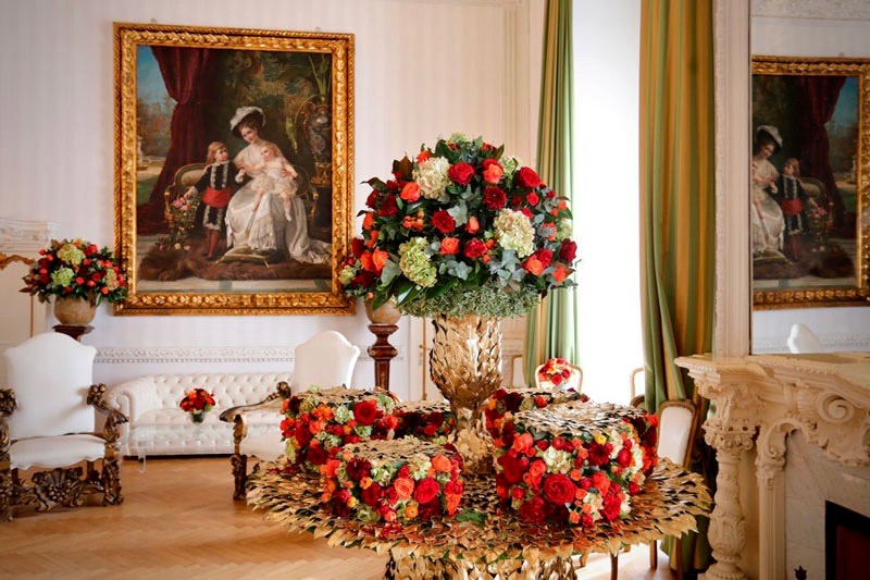 A colourful flower details with beautiful red and white flowers in elegant wedding hall entrance