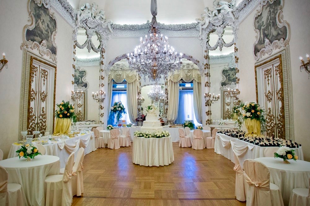 elegant and rich wedding hall in white colours, mirrors, beautiful chandeliers for wedding dinners