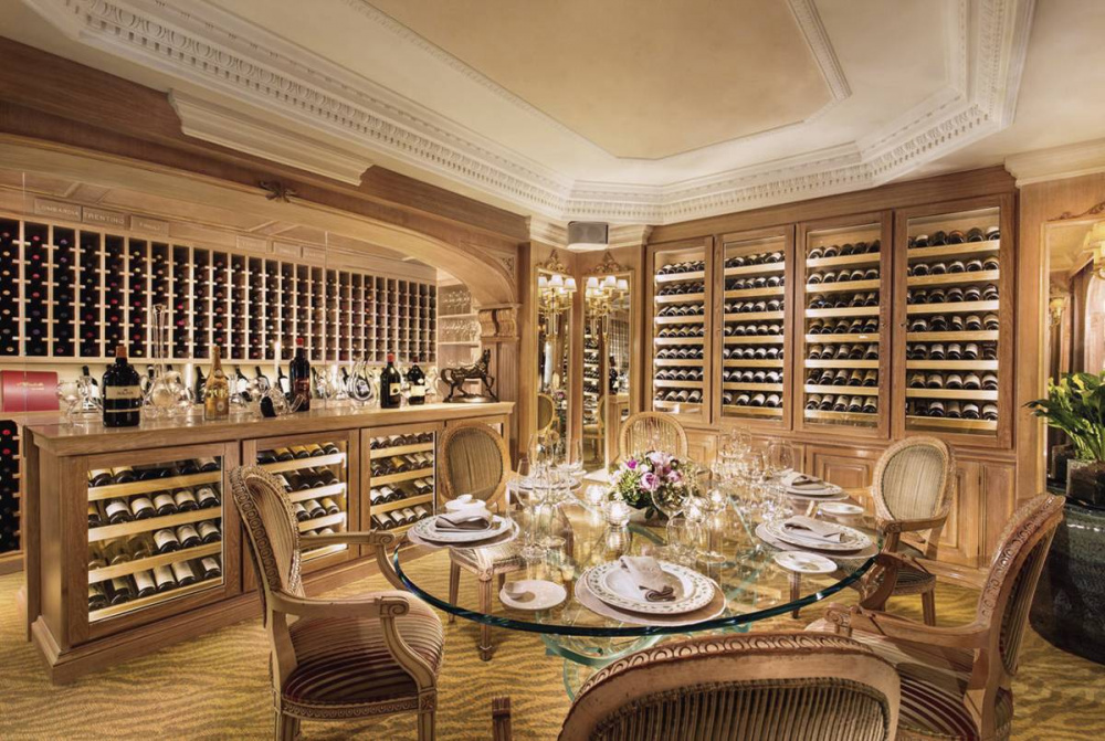 elegant dinner setup in wine cellar unique crystal table anf fresh flowers initmate weddings only