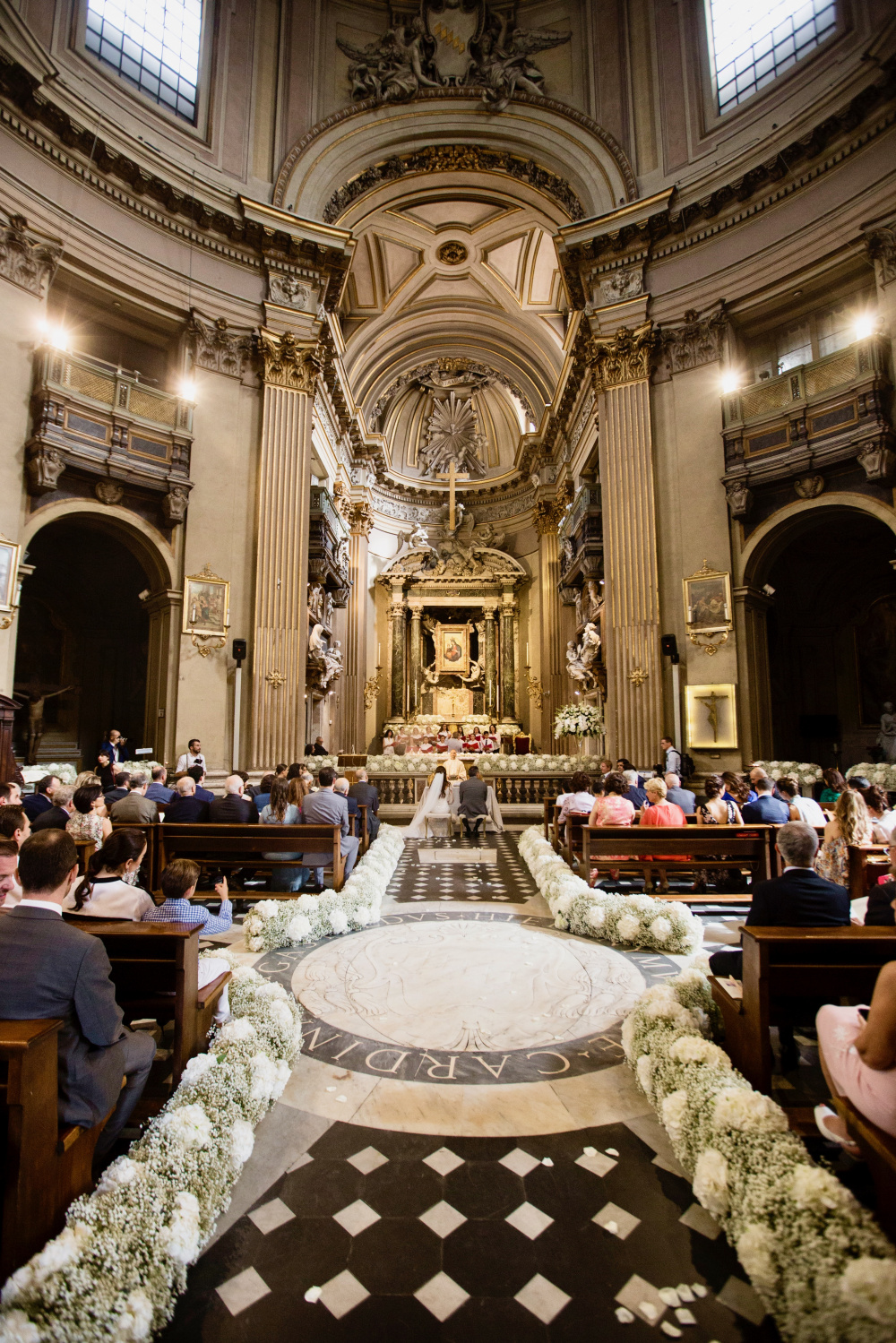 glimpse of the enchanting church in Rome during a real wedding, green and white fresh flower decors