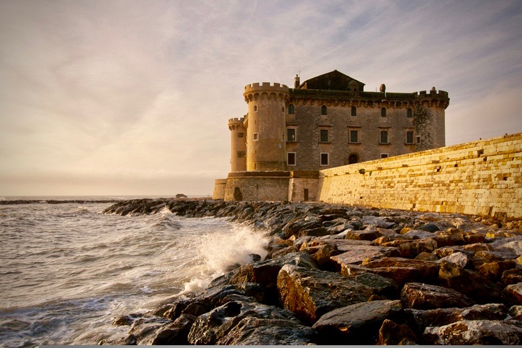 An amazing view of the castle by the sea coast at sunset, a super romantic location,