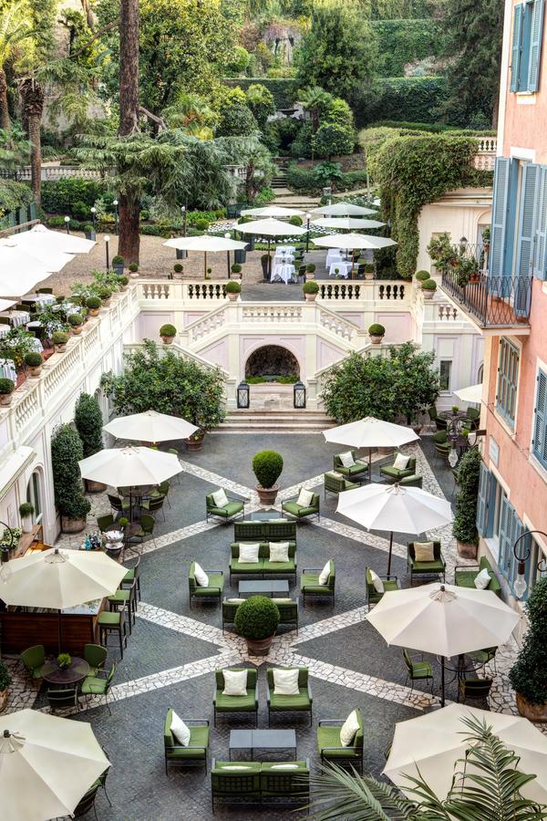 Courtyard with lounge area surrounded by a terrace and gardens in Rome for wedding receptions