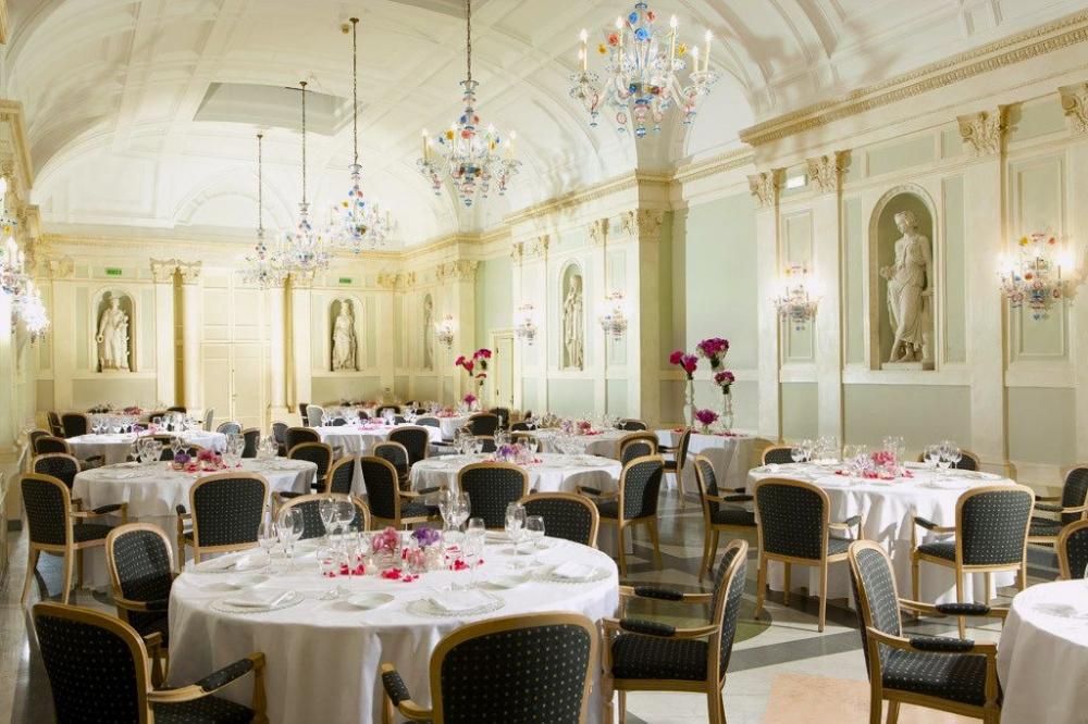 Elegant Ballrooom with murano glass chandeliers and marble sculpures perfect for wedding dinners