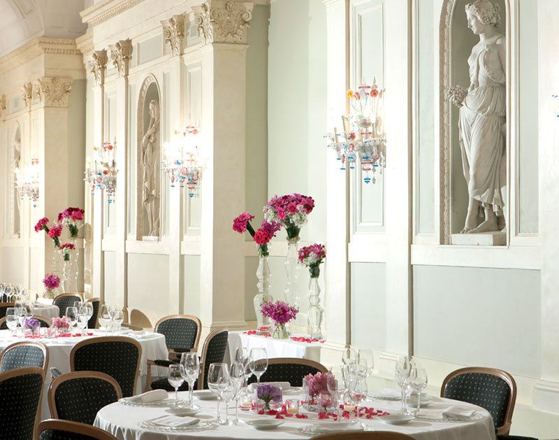 Main Ballroom's wedding dinner set-up with fresh pink flowers on the tables, detail of fine decors