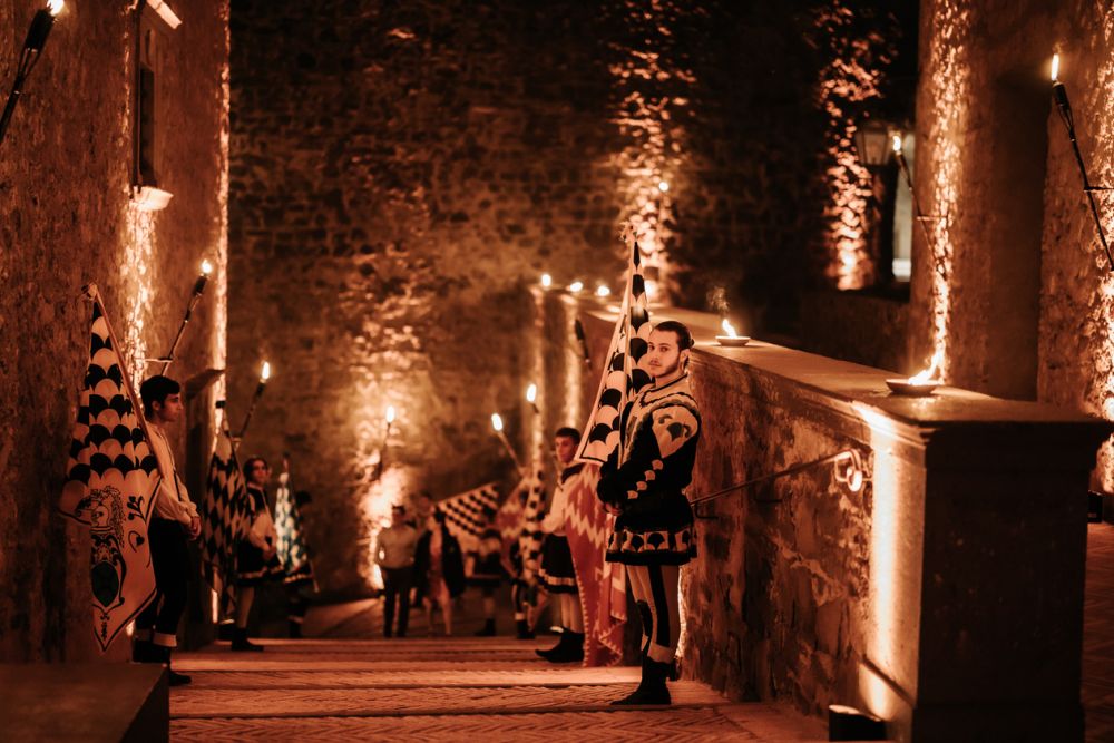 Night walk with flag throwers at wedding castle in Rome