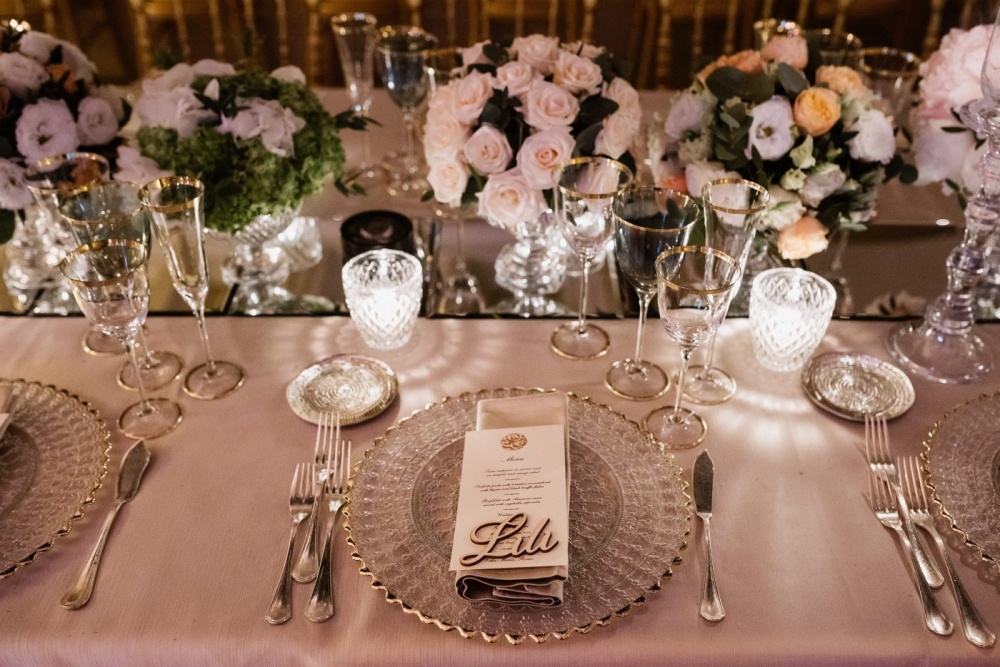 Table decor with cutglasses chargers, printed menu, pink flowers and mirrors