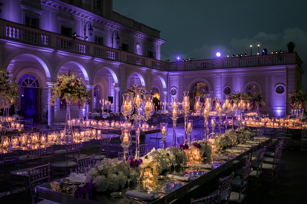 Table decor in a villa with candelabras, orchids, candles and mirror tables