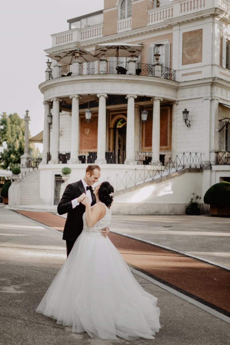 Bride and groom dancing in front of a villa in Rome