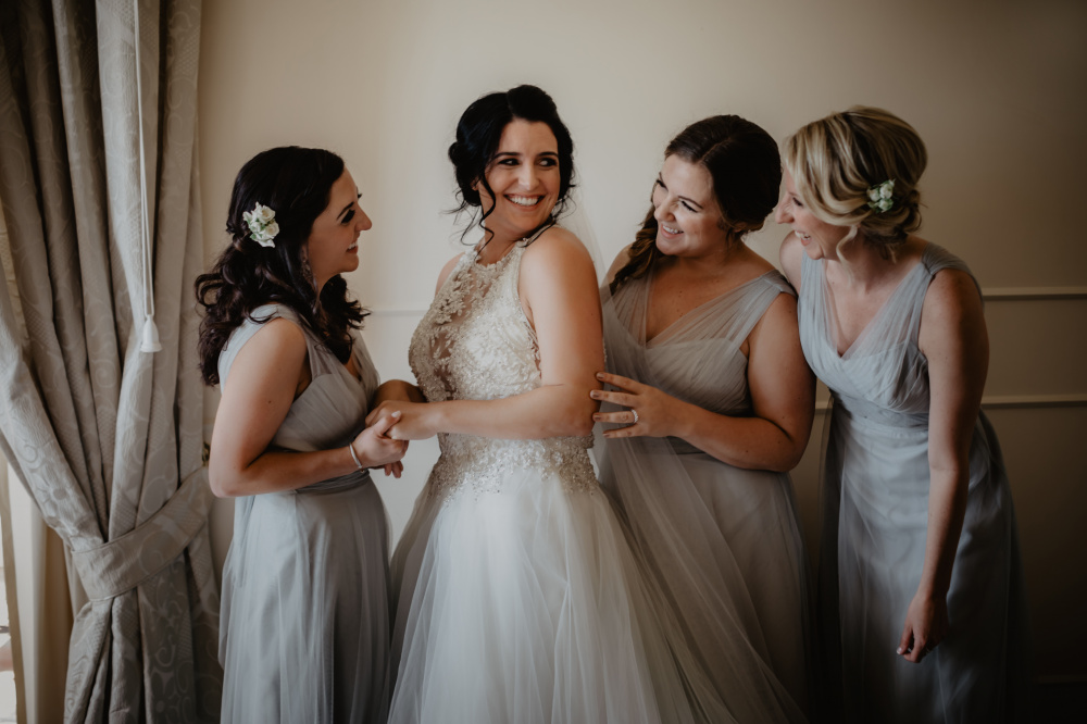 three bridesmaids and the bride with white and light grey dresses