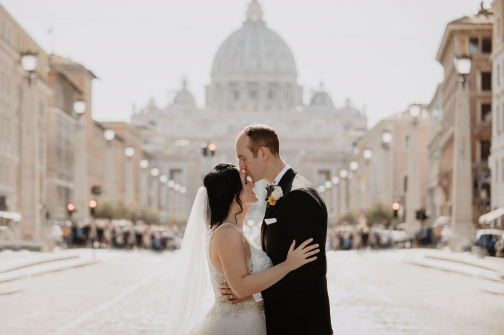 Groom kisses the bride in Vatican Rome