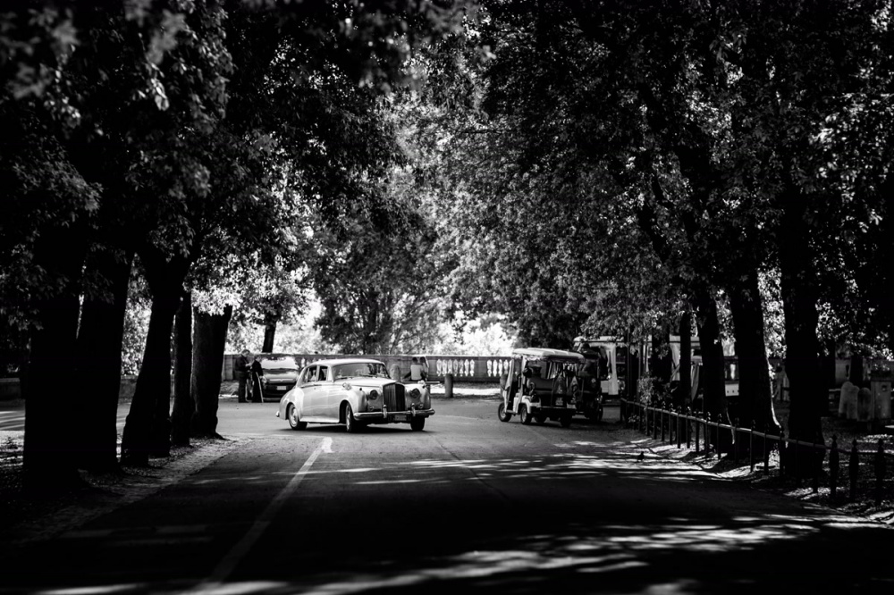 Bride and groom arrive at the venue with a vintage car