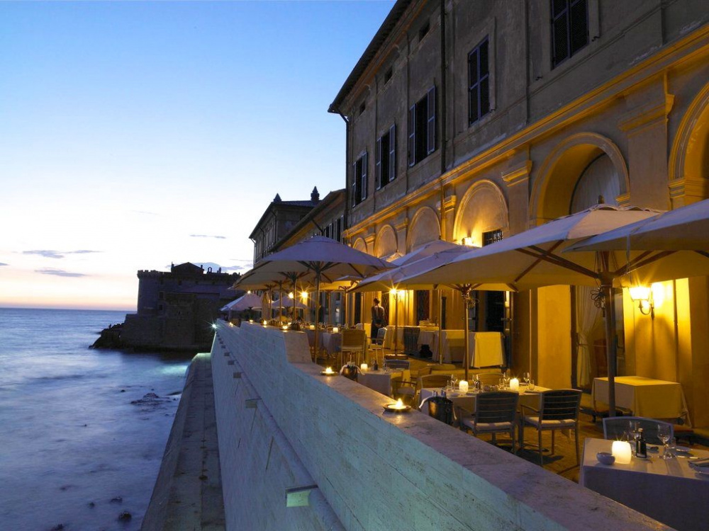 night view restaurant's terrace over sea old castle as background for romantic pre-wedding dinner