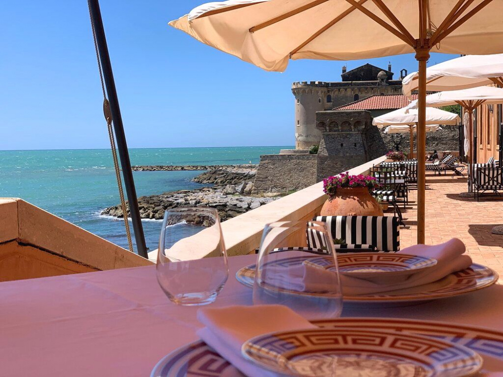 detail of the view from one of the restaurant's lunch table over the sea and old castle on the back