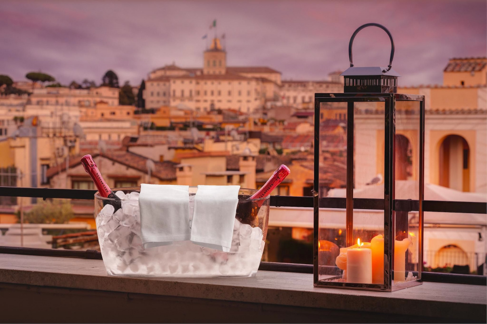 before wedding romantic apero view over roman historical monuments at sunset candles prosecco