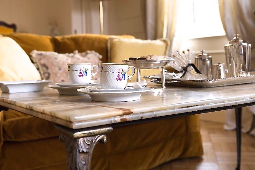 detail of elegant tea time set-up in a marble table