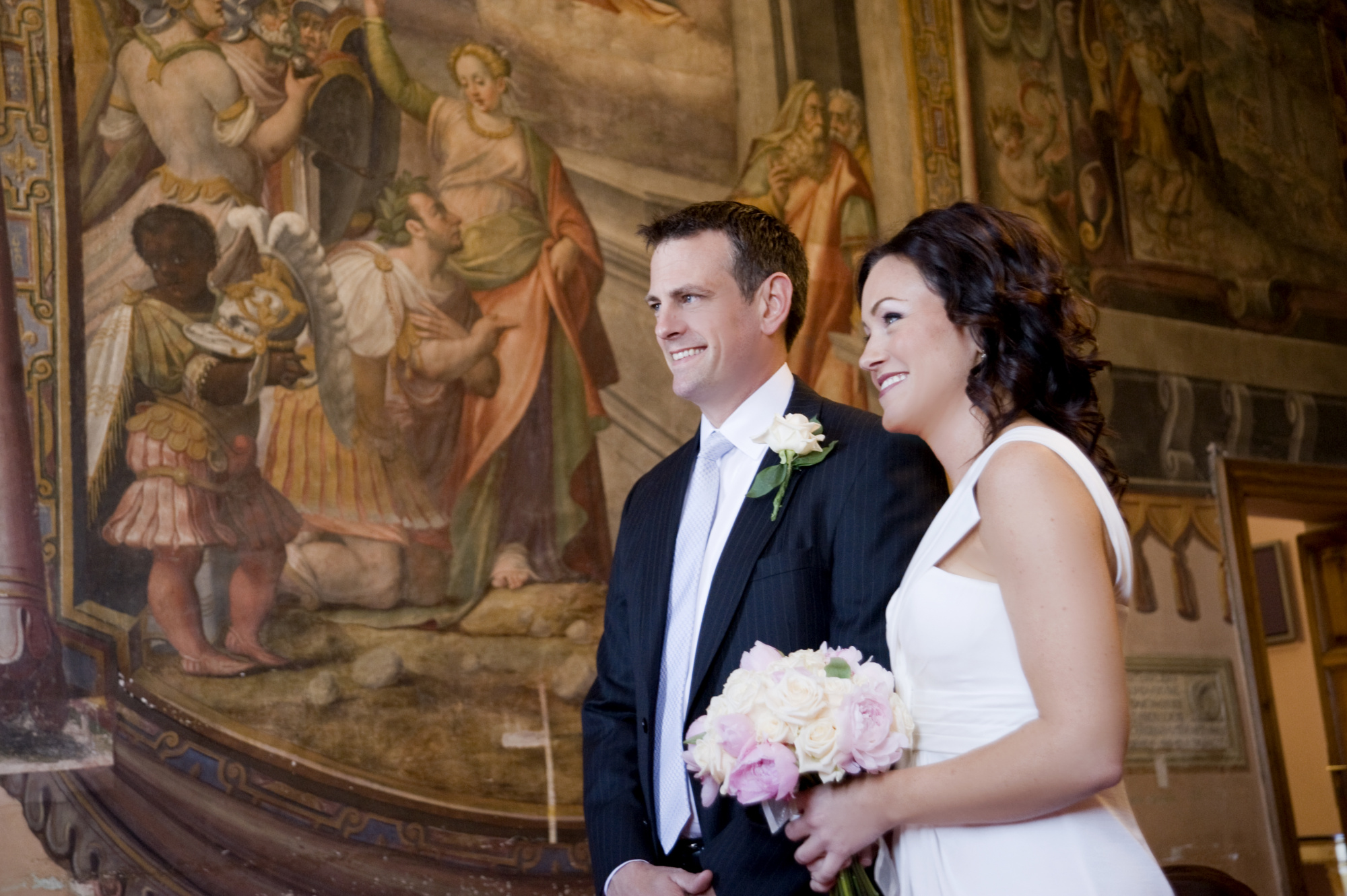 Bride holding a beautiful bouquet and groom in a romantic civil wedding in Rome